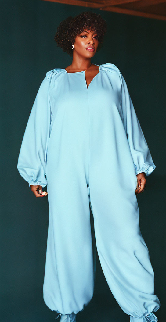 Stylish woman in light blue jumpsuit with bishop sleeves