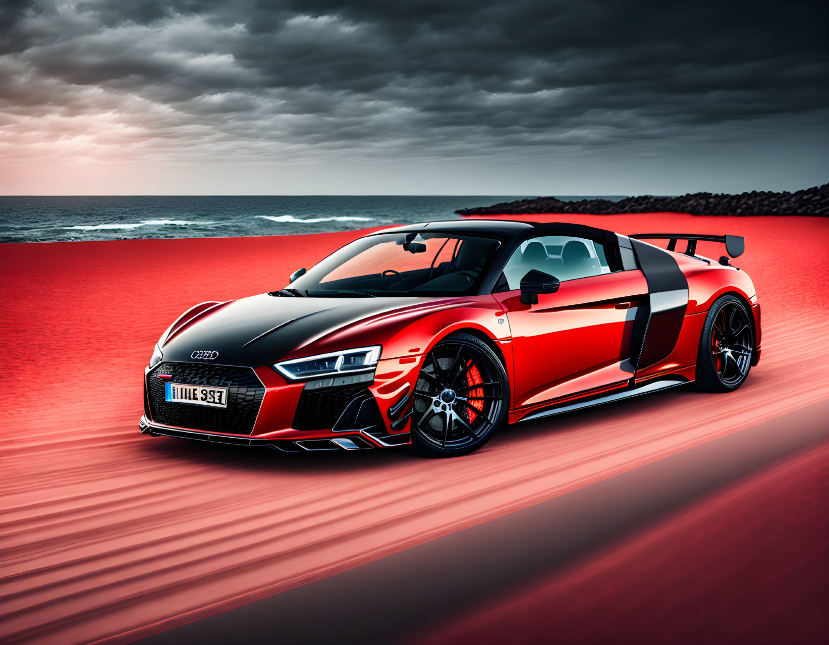 Red and black Audi R8 sports car on sandy beach under dramatic red skies