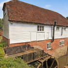 Serene pastoral landscape with quaint watermill