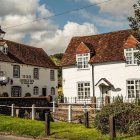 Picturesque white cottages and traditional pub in a quaint village setting