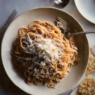 Spaghetti with Meaty Tomato Sauce and Cheese Garnished with Herbs