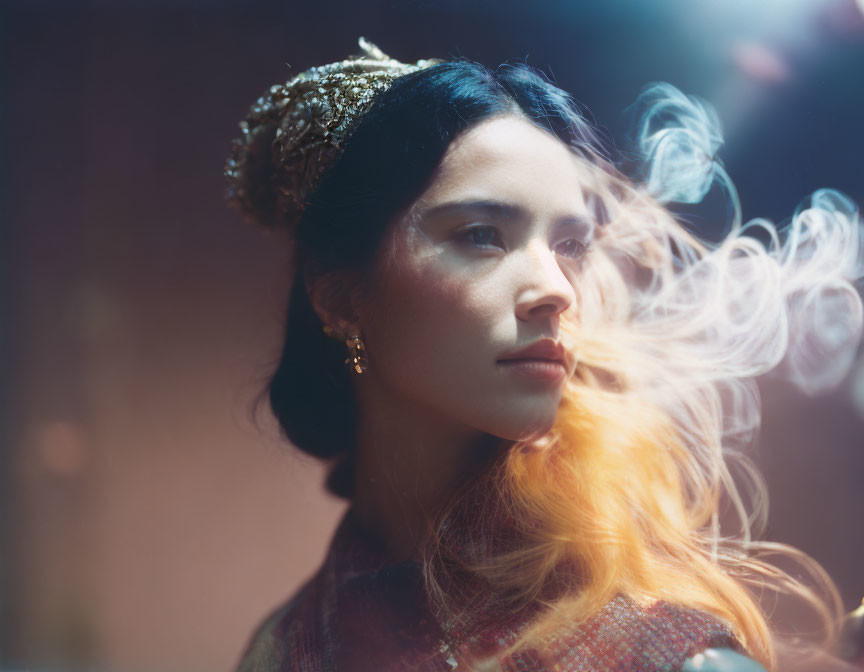 Majestic woman with crown under soft light and smoke swirls