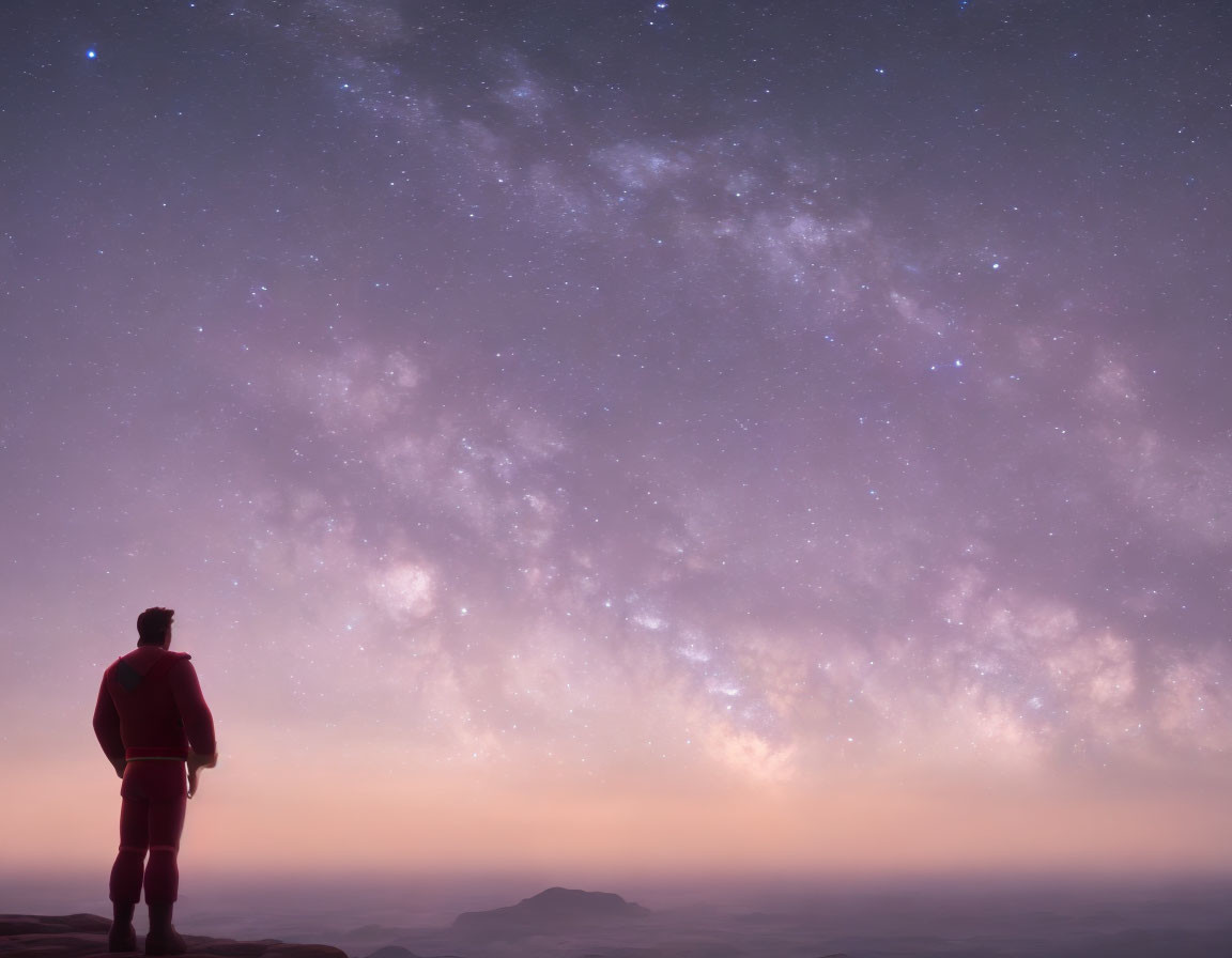 Silhouette of person on hill under starry Milky Way at twilight