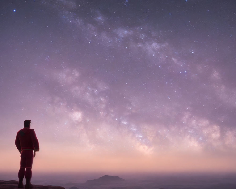 Silhouette of person on hill under starry Milky Way at twilight