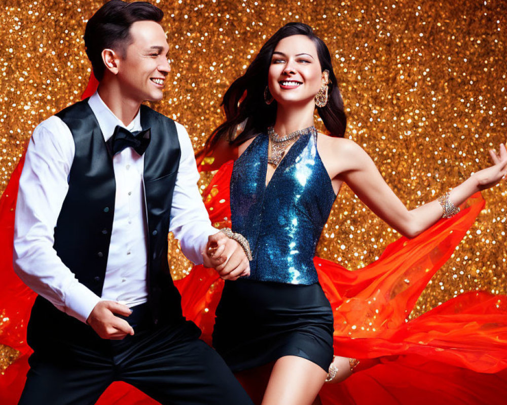 Formally dressed couple dancing and laughing on gold background