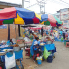 Colorful Market Scene with Traditional Attire and Various Stalls