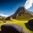 Grass-covered terraced pyramid under blue sky in mountainous landscape