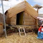 Traditional Reed Hut on Floating Island with Indigenous Woman and Handmade Crafts