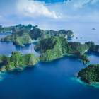 Tranquil seascape with green islands and cloudy sky