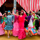 Vibrant flamenco dancers in frilly dresses at outdoor event