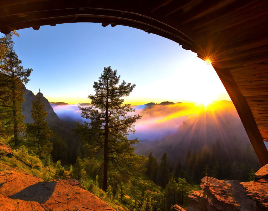 Scenic sunrise view from wooden cabin over misty forest valley