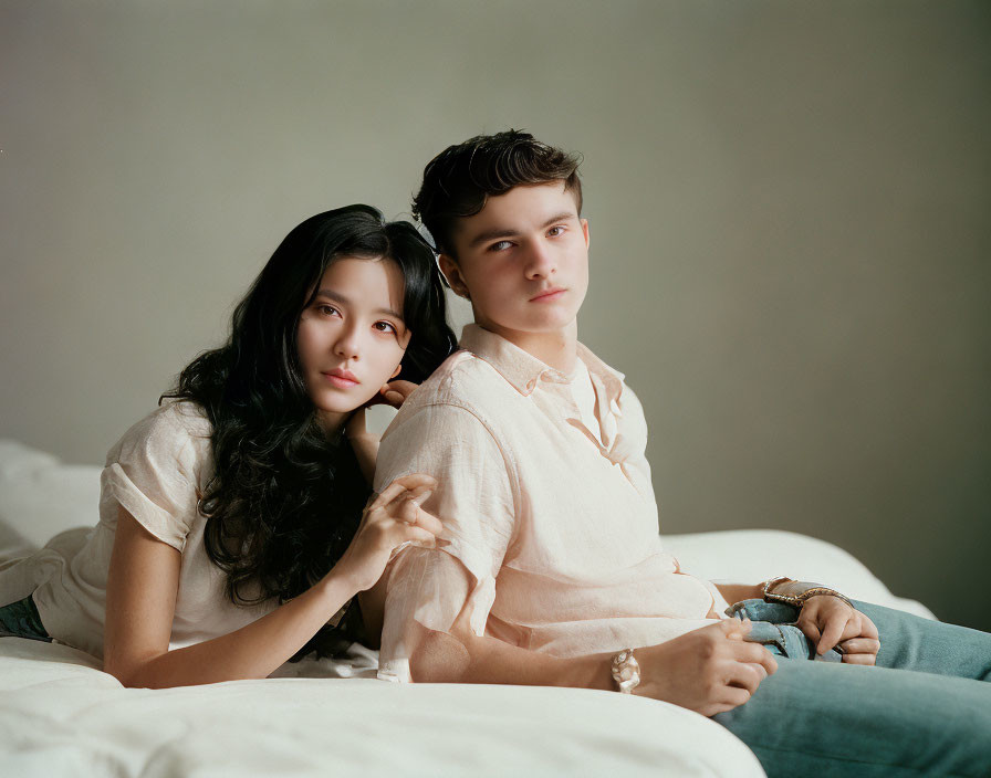 Young Couple Sitting Together in a Softly Lit Room