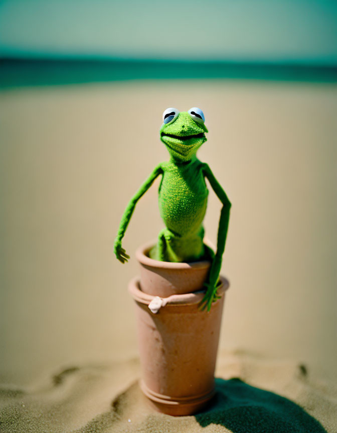 Kermit the Frog Plush Toy in Terracotta Pot on Sandy Beach