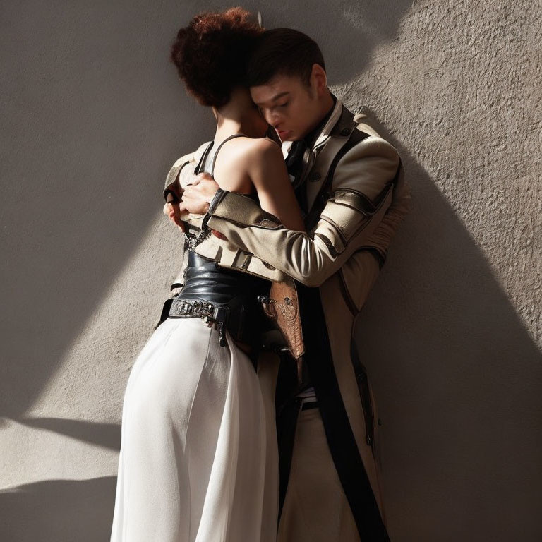 Affectionate embrace between two people against textured wall