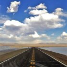 Surreal image: Elephants on road under cloudy sky