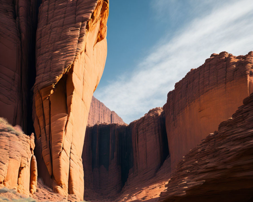 Majestic red sandstone cliffs mirrored in serene water under a blue sky