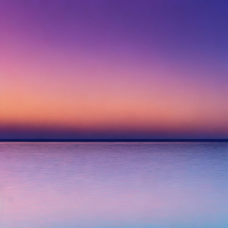 Vibrant sunset colors over calm ocean: purple, pink, blue