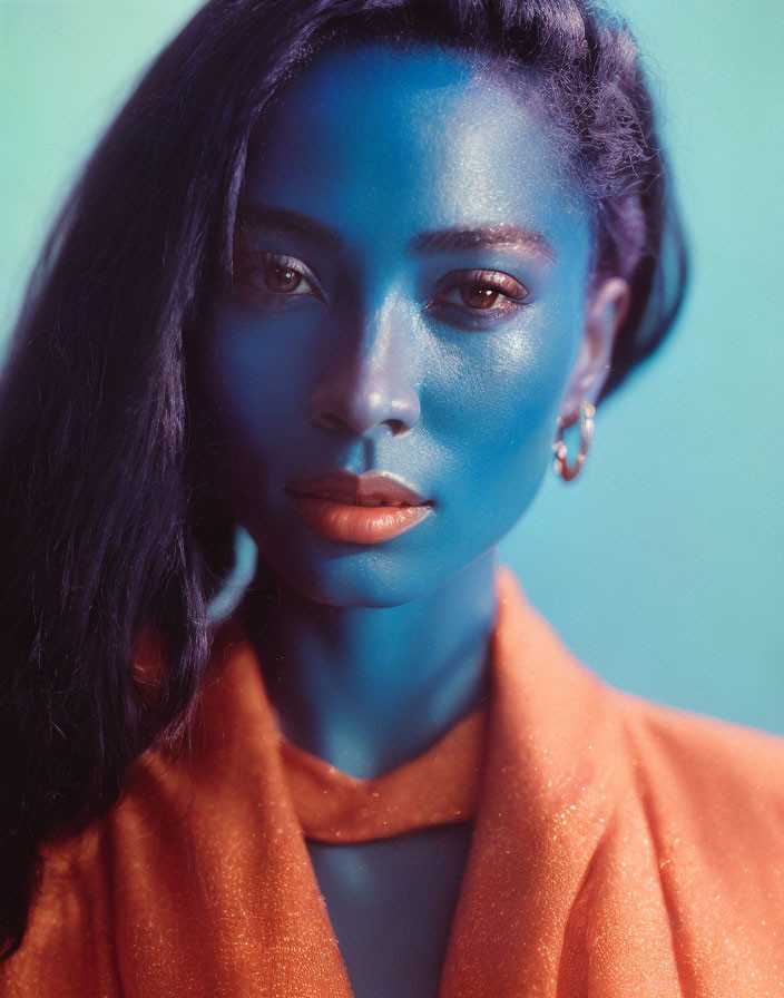 Artistically colored blue and natural tones portrait against teal background