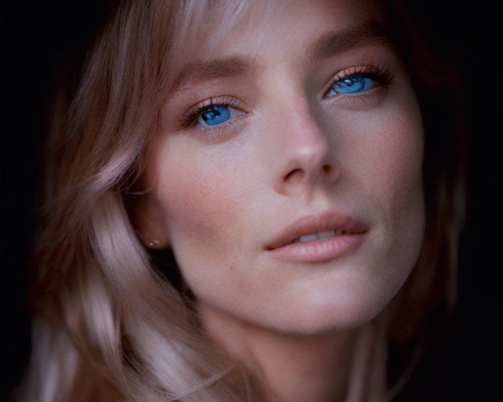 Portrait of a Woman with Blue Eyes and Blonde Hair on Dark Background