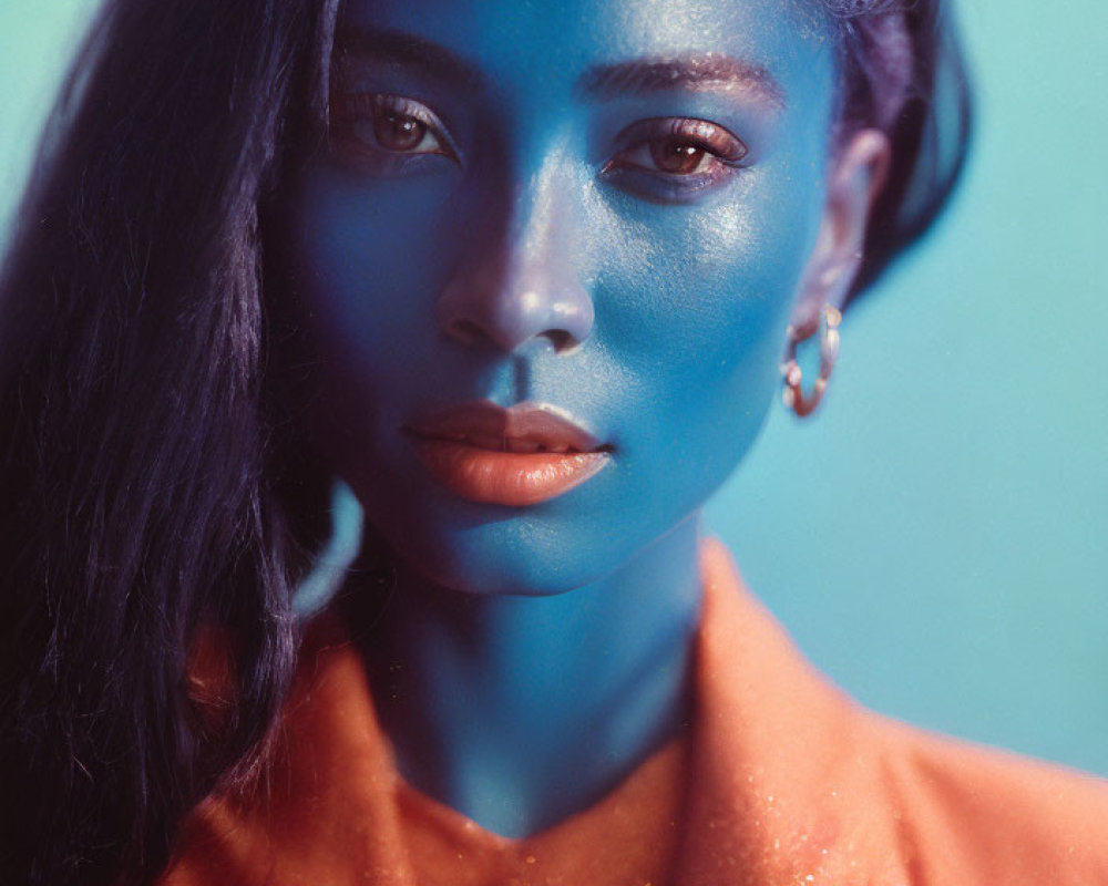 Artistically colored blue and natural tones portrait against teal background