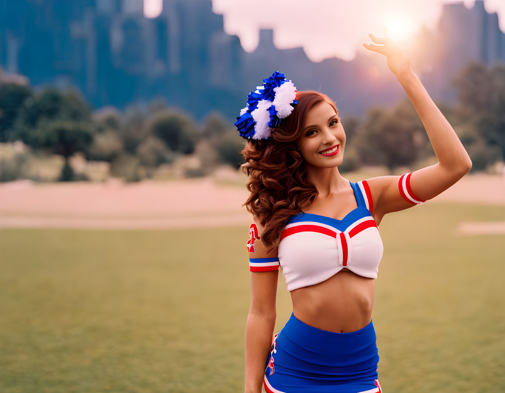 Cheerful cheerleader with pompom headband holding the sun at dusk