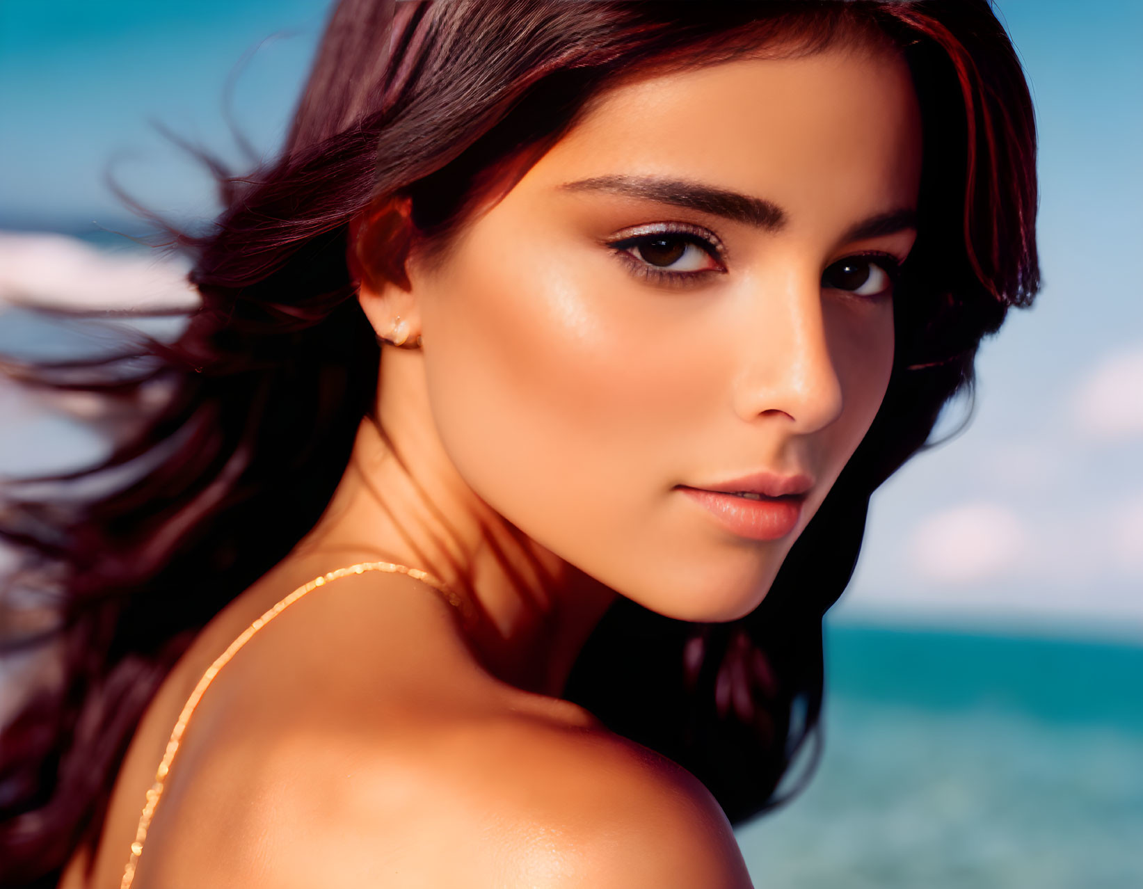 Portrait of Woman with Tanned Skin and Dark Hair by the Sea