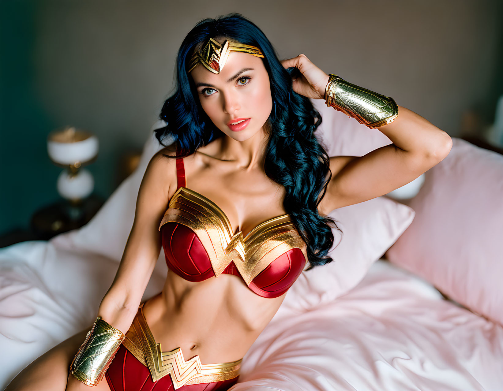 Wonder Woman costume on bed with satin sheets and iconic accessories