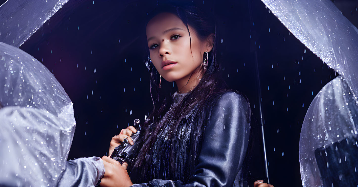 Person under clear umbrella gazing in rain with water droplets and glistening black adornments