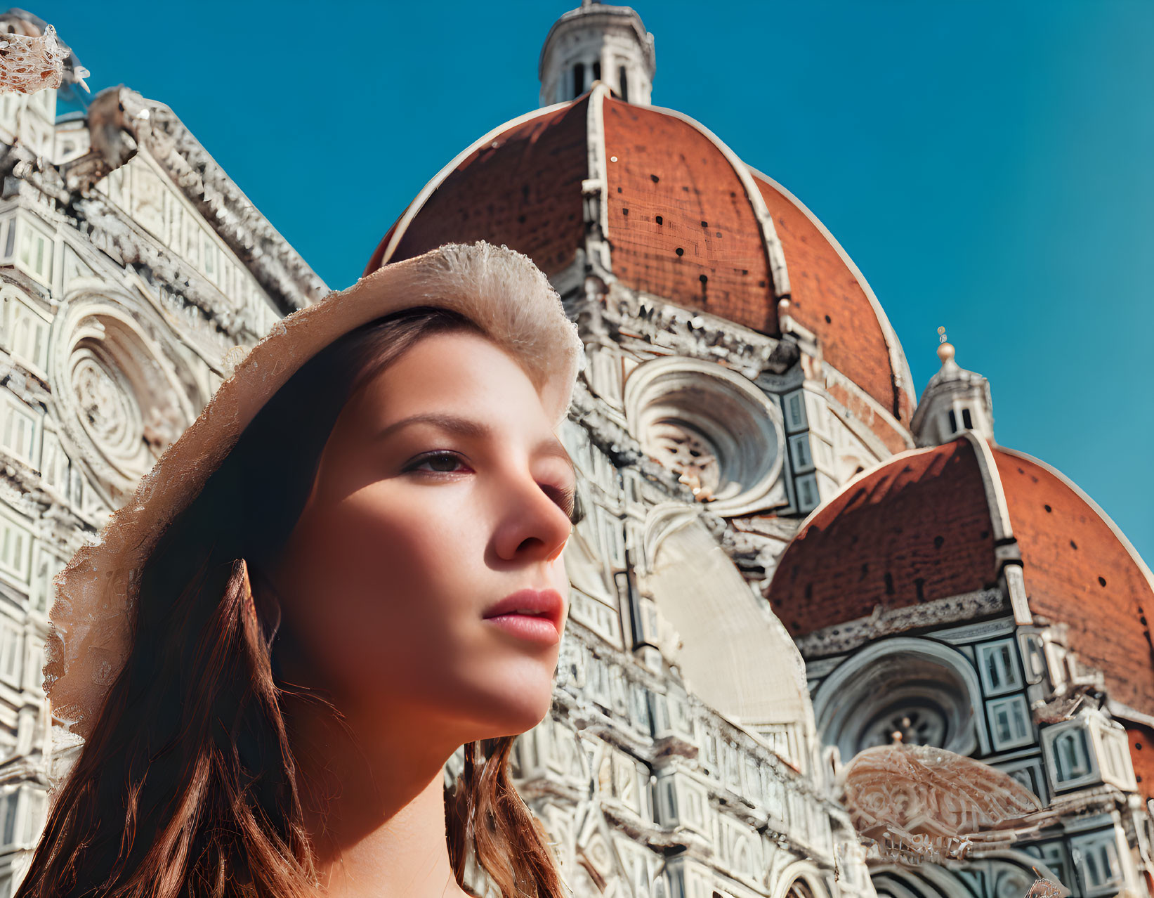 Woman in sunhat with Florence Cathedral in background.