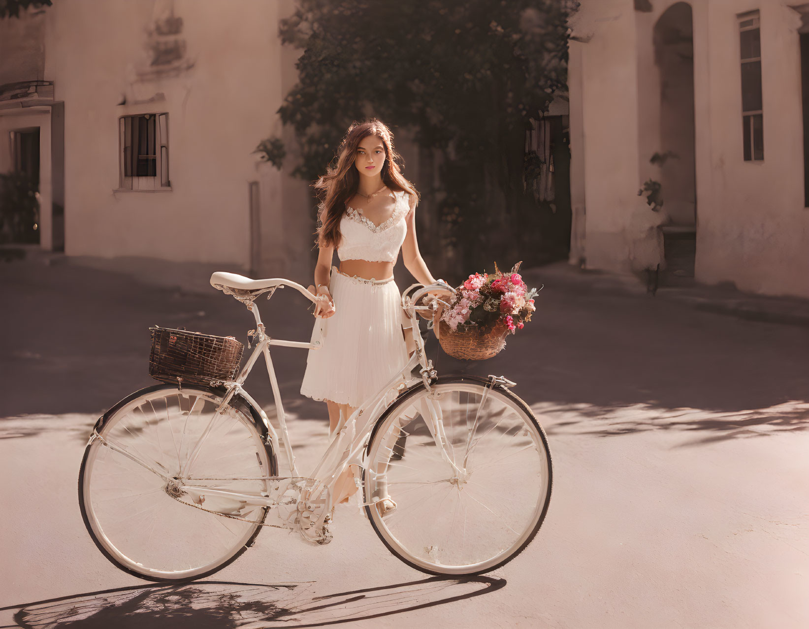 Woman in white dress with vintage bicycle and flowers on sunny street