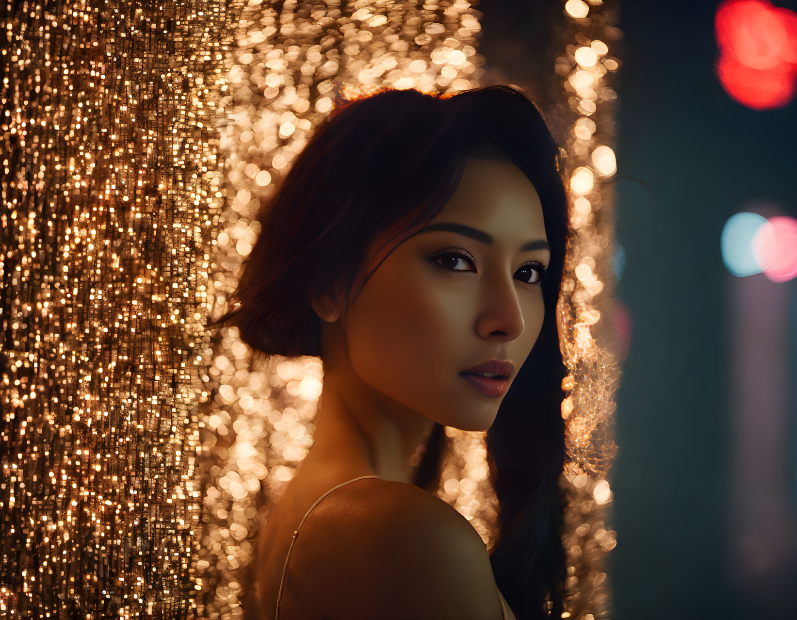 Intense gaze woman in front of sparkling light background