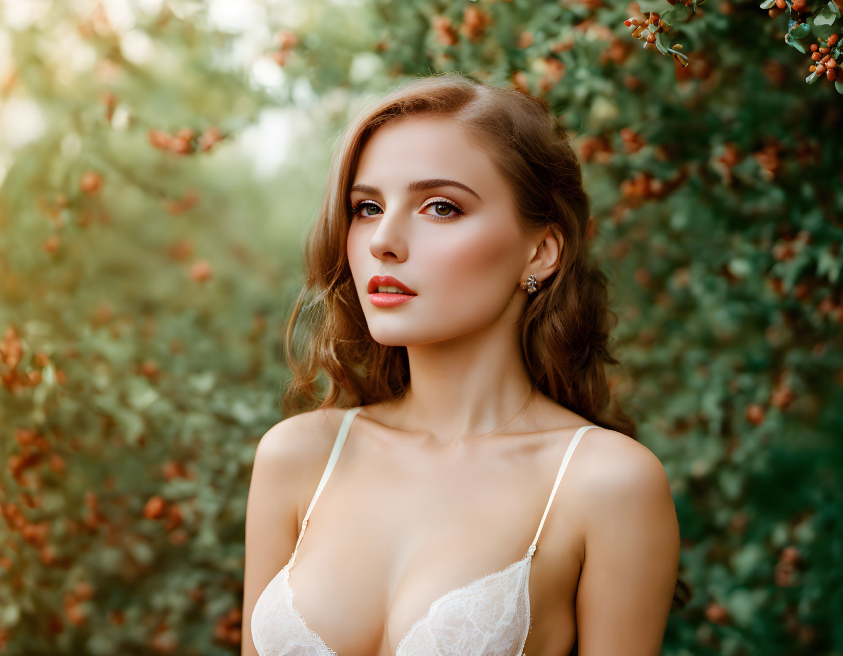 Styled woman in lace top with green leaves backdrop