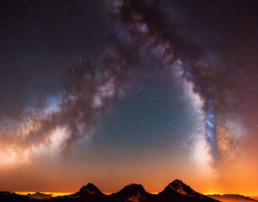 Stunning Milky Way over silhouetted mountains at night