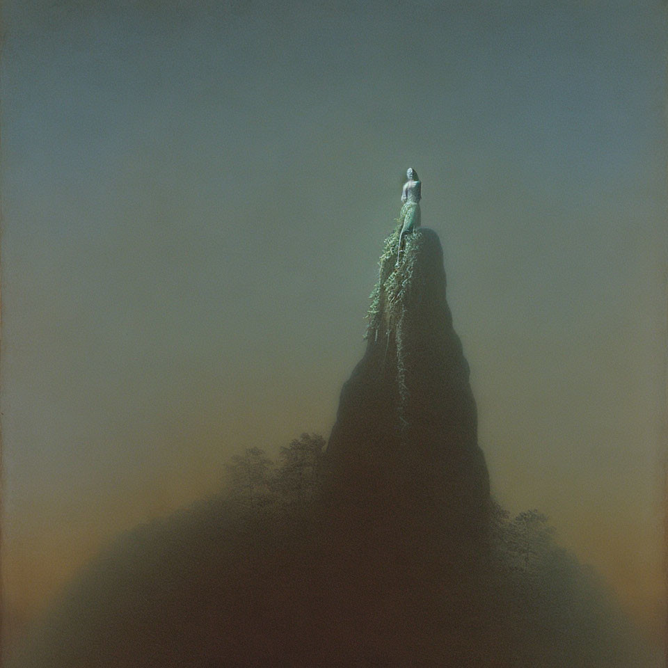 Person standing on steep rock formation in misty ambiance with cascading foliage