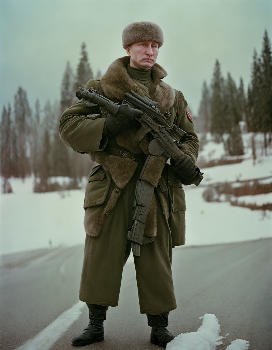 Person in winter military attire with fur hat holding assault rifle on snowy roadside