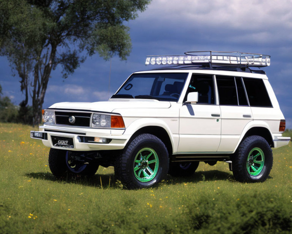 Vintage White SUV with Green Rims Parked in Grass Field