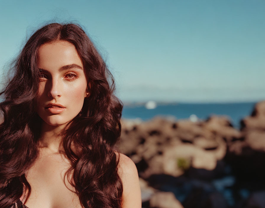 Long-Haired Woman Posing by Sea and Rocky Shore