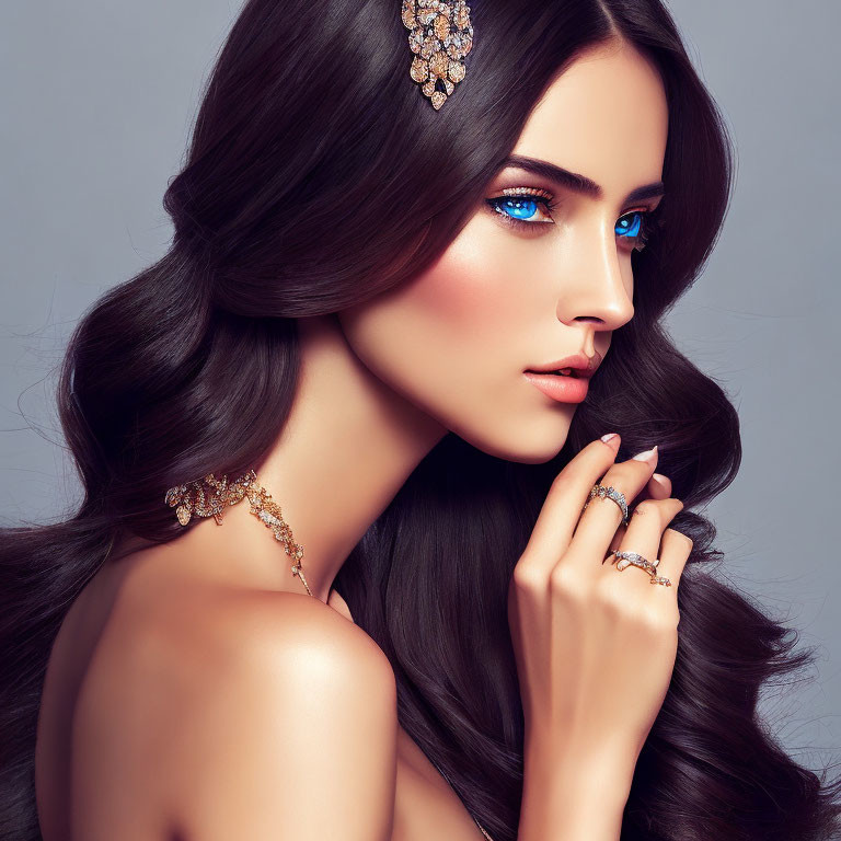 Woman with Long Dark Hair and Gold Jewelry in Sparkling Blue Eye Makeup