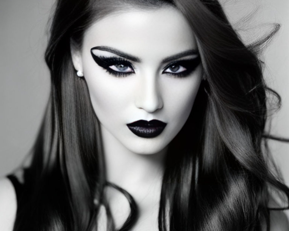 Monochrome portrait of a woman with bold eye makeup and black lipstick