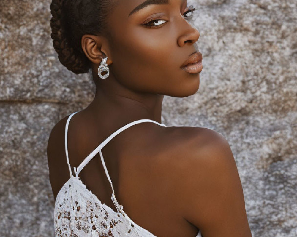 Woman in Braided Hair and Striking Makeup Poses in White Lace Dress