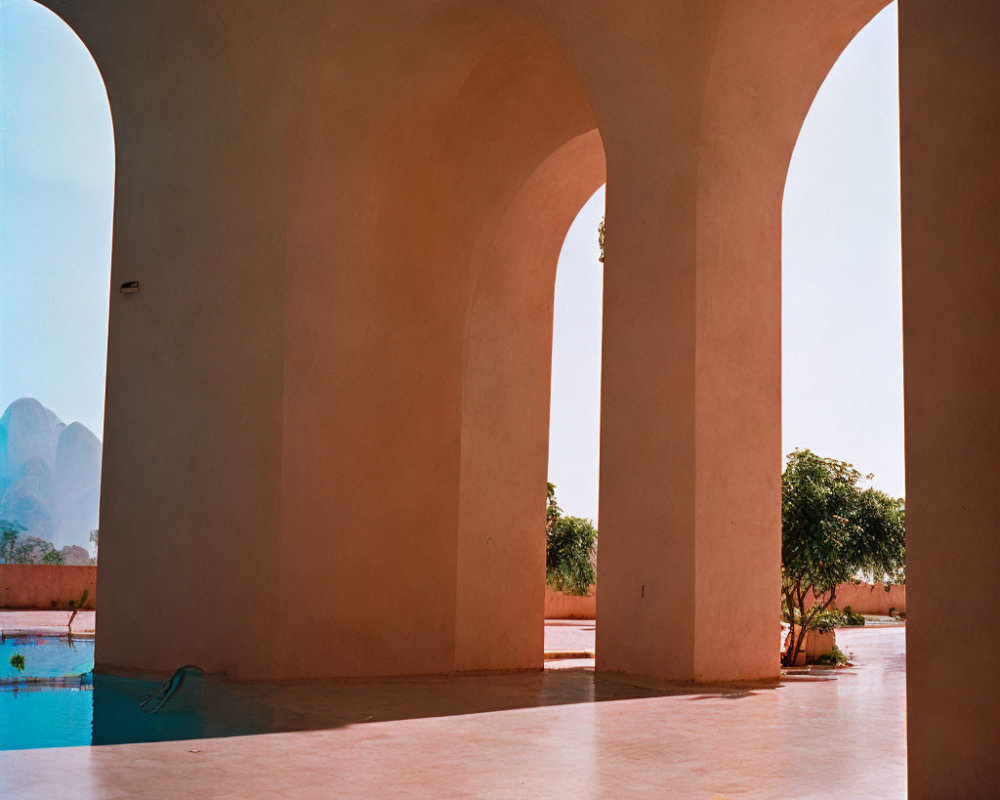 Minimalistic Arched Walkway Overlooking Pool and Mountainscape