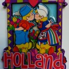 Vibrant stained-glass-style village artwork with heart sun and border