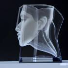 Crystal sculpture: Two stylized human profiles on dark background