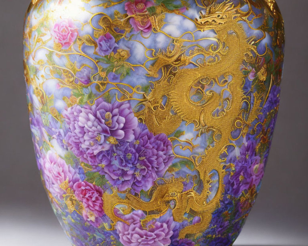 Gold-embossed dragon vase with vibrant floral patterns on glossy surface