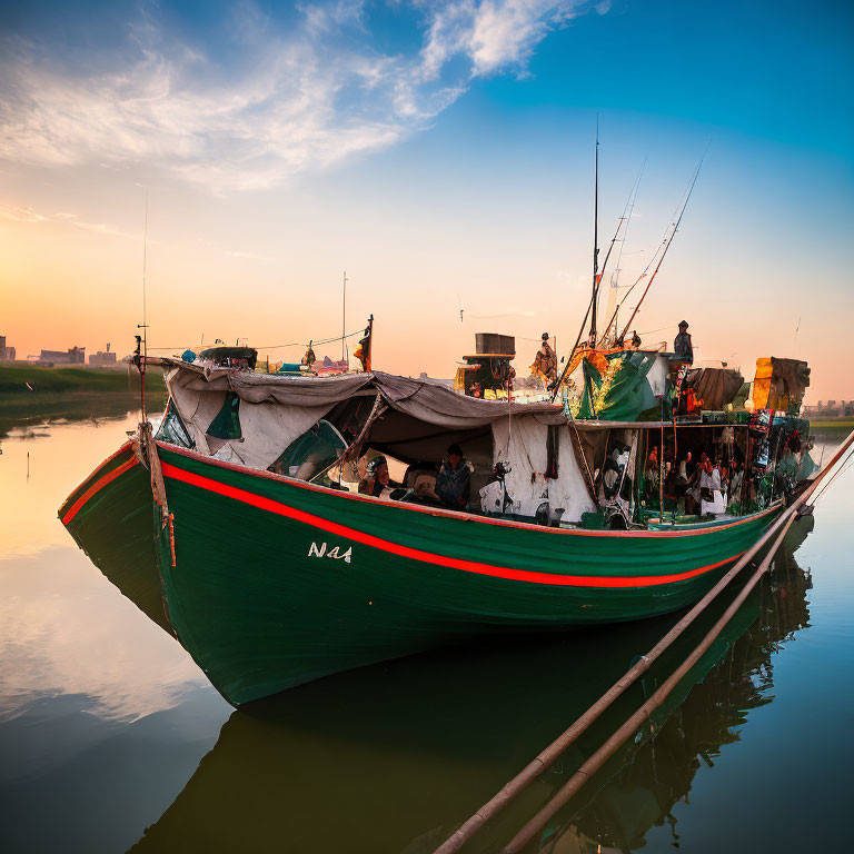 Green and Red Fishing Boat Moored at Sunset with Cityscape Background