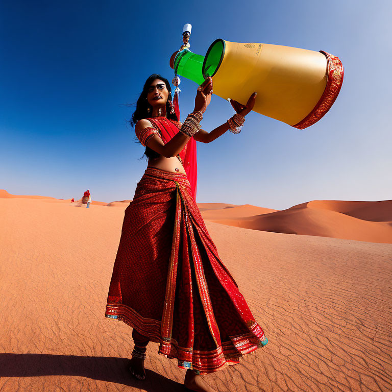 Woman in red saree carries yellow water container in desert landscape