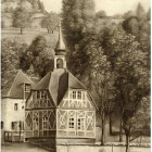 Sepia-Toned Image of European-Style House Surrounded by Trees