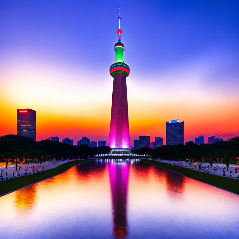 Illuminated tower with purple glow reflecting in water against sunset sky