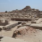 Ancient town with rustic buildings and golden dome under clear sky