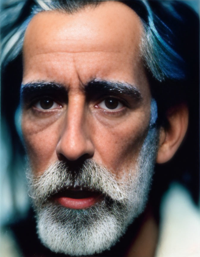 Man with Greying Beard and Hair, Blue Streak, Intense Gaze, Dark Eyeb